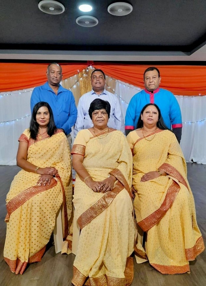 A group of people standing and sitting