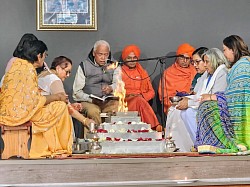 Group of people sitting around a havan kund