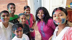 Group of children with coloured powder smeared on their faces