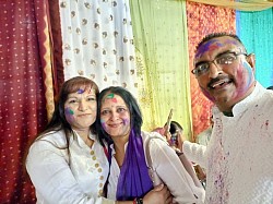 2 females and a male with coloured powder on their faces