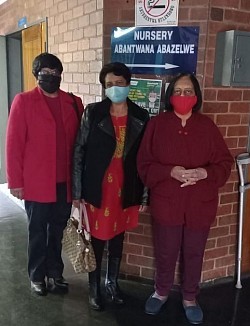 Three women standing in a hospital