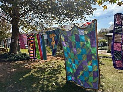 Colourful knitted blankets on display outdoors