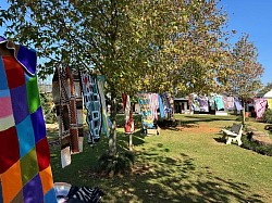 Colourful knitted blankets on display outdoors