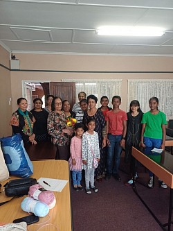 Group of adults and children in a classroom