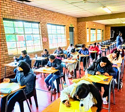 Children and adults sitting for an exam