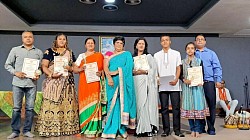 A group of people on stage holding certificates