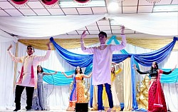 Group of children participating in a traditional dance item on stage