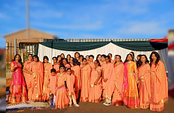 Group of women and children wearing traditional indian attire posing for the camera